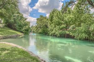 a river with green water and trees on the side at CRC 317 Timeless Tranquility in New Braunfels
