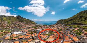 an aerial view of a city with a red circle at Refúgio Machiquense in Machico