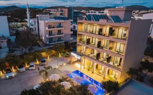an aerial view of a building with cars parked in a parking lot at Hotel Resol 2 in Ksamil
