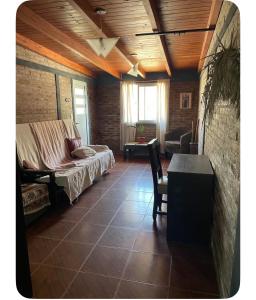 a bedroom with a bed and a table in a room at Tres Raíces in Miramar