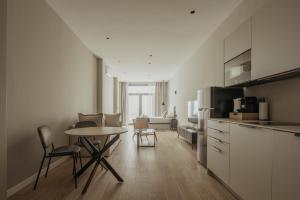 a kitchen with a table and chairs in a room at Suites 43 Juan Llorens in Valencia