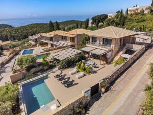 an aerial view of a house with a swimming pool at Christie's Luxury Suites by Dandy Hospitality in Syvota
