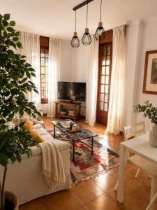 a living room with a couch and a table at Casa Bolumburu in Pontevedra