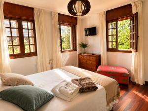 a bedroom with a bed with two towels on it at Casa Bolumburu in Pontevedra