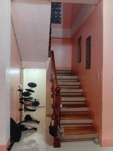 a staircase in a house with shoes on the floor at Bato transient house in Bato +6 photos