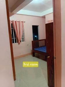 a room with a bunk bed and a window at Bato transient house in Bato