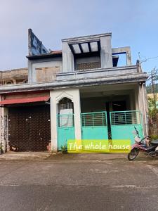 a building with a motorcycle parked in front of it at Bato transient house in Bato