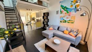 a living room with a couch and a table at La Suite Limoncello, Sunny & Spacious in Nîmes