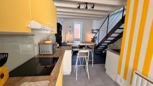 a small kitchen with a table and a dining room at La Suite Limoncello, Sunny & Spacious in Nîmes