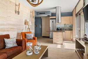 a living room with a couch and a table at Christie's Luxury Suites by Dandy Hospitality in Syvota