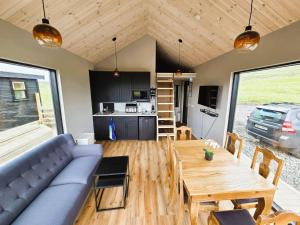 a living room with a couch and a wooden table at Northern Lights Cabin - Syribr in Grímsnes og Grafningshreppur