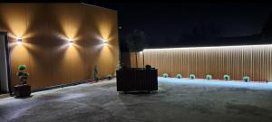 a building with a wall with lights on it at Divine Apartmani in Dobanovci