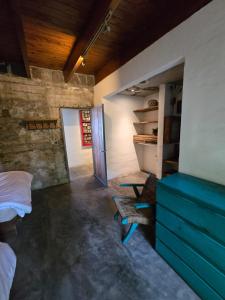 a bedroom with a bed and a blue dresser at Linda Casa in Isla Tzilinabaj