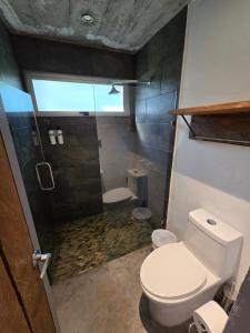 a small bathroom with a toilet and a shower at Linda Casa in Isla Tzilinabaj