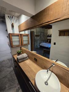 a bathroom with a sink and a mirror at Linda Casa in Isla Tzilinabaj