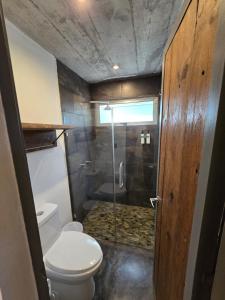 a small bathroom with a toilet and a shower at Linda Casa in Isla Tzilinabaj +24 photos
