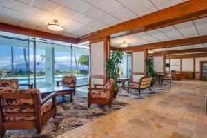 an empty lobby with tables and chairs and windows at Lahaina Shores 320 in Lahaina +19 photos