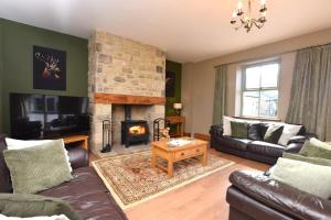 a living room with a couch and a fireplace at 3 Bed in Consett oc-29403 in Lanchester