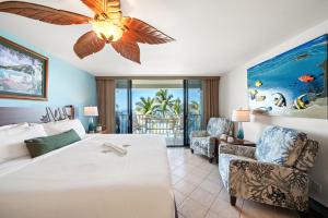 a bedroom with a large bed with a ceiling fan at Lahaina Shores 517 in Lahaina +50 photos
