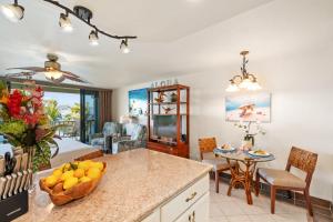 a kitchen and living room with a table and chairs at Lahaina Shores 517 in Lahaina