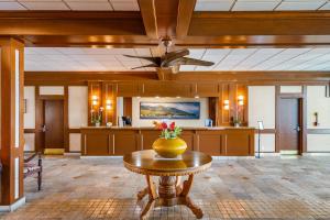 a lobby with a table with a vase on it at Lahaina Shores 517 in Lahaina