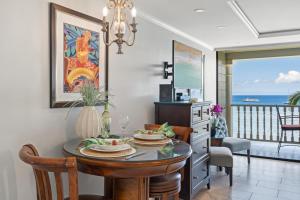 a dining room with a table and a view of the ocean at Lahaina Shores 511 in Lahaina