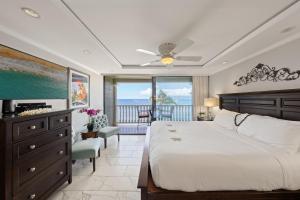 a bedroom with a bed and a view of the ocean at Lahaina Shores 511 in Lahaina +45 photos