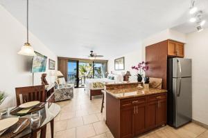 a kitchen and living room with a stainless steel refrigerator at Lahaina Shores 515 in Lahaina