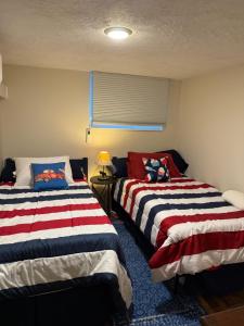 two beds sitting next to each other in a room at Dragonfly Cottage in Plymouth