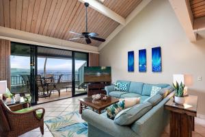 a living room with a couch and a television at Kahana Village 4 in Lahaina