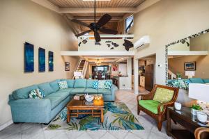 a living room with a blue couch and a table at Kahana Village 4 in Lahaina