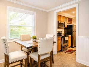 a dining room with a table and chairs and a kitchen at Relaxing Condo with Parking - Minutes to Old Town! in Scottsdale
