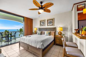 a bedroom with a bed and a balcony with the ocean at Lahaina Shores 631 in Lahaina +43 photos