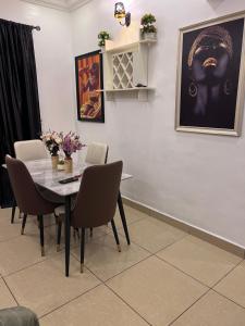 a dining room with a table and chairs at New Luxury in Gwarinpa