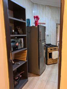 a kitchen with a stainless steel refrigerator and a stove at New Luxury in Gwarinpa