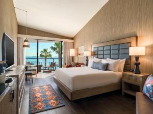 a bedroom with a large bed and a living room at The Maya in Long Beach