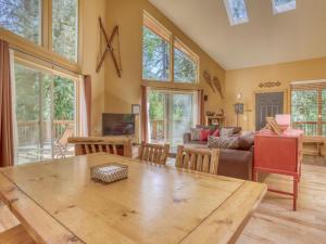 a living room with a table and a couch at Salmon River Chalet - Meredith Lodging in Welches