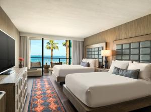 two beds in a hotel room with a view of the ocean at The Maya in Long Beach +35 photos