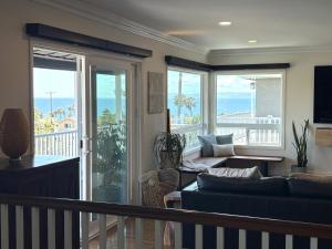 a living room with a couch and a balcony at Casa Pacifica in San Pedro