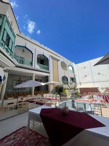 a building with tables and umbrellas in front of it at Morjana Castle in Sousse