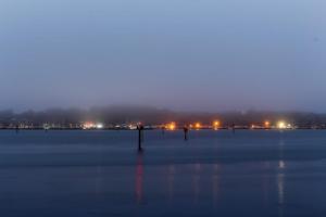 a view of a large field at night with lights at Bayside Cottage in Bodega Bay