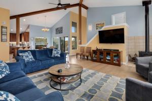 a living room with blue couches and a table at Eagle's Nest in Bodega Bay