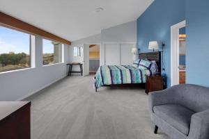 a bedroom with a bed and a couch and a chair at Eagle's Nest in Bodega Bay