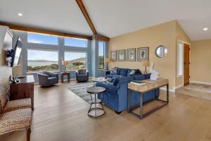 a living room with a blue couch and a table at Eagle's Nest in Bodega Bay