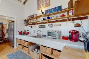 a kitchen with a sink and a refrigerator at Mar-Tiny in Bodega Bay