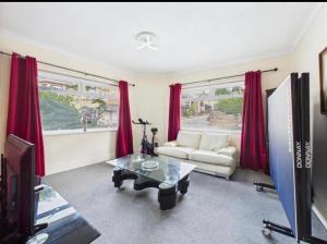 a living room with red curtains and a couch at Lake District Gate in Lancaster