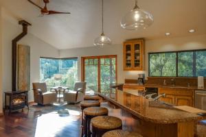 a kitchen with a large counter with stools in it at Leslie Creek House in Mark West Springs