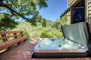 a hot tub sitting on a patio with a bench at Leslie Creek House in Mark West Springs
