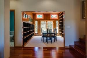 a dining room with a table and chairs in a library at Leslie Creek House in Mark West Springs