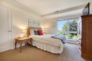 a bedroom with a large bed and a window at Harbour House in Bodega Bay